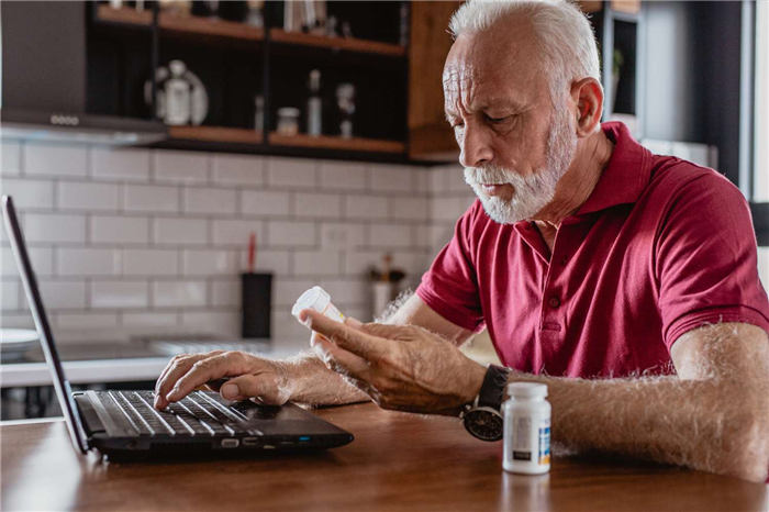 Man reading about medicine online